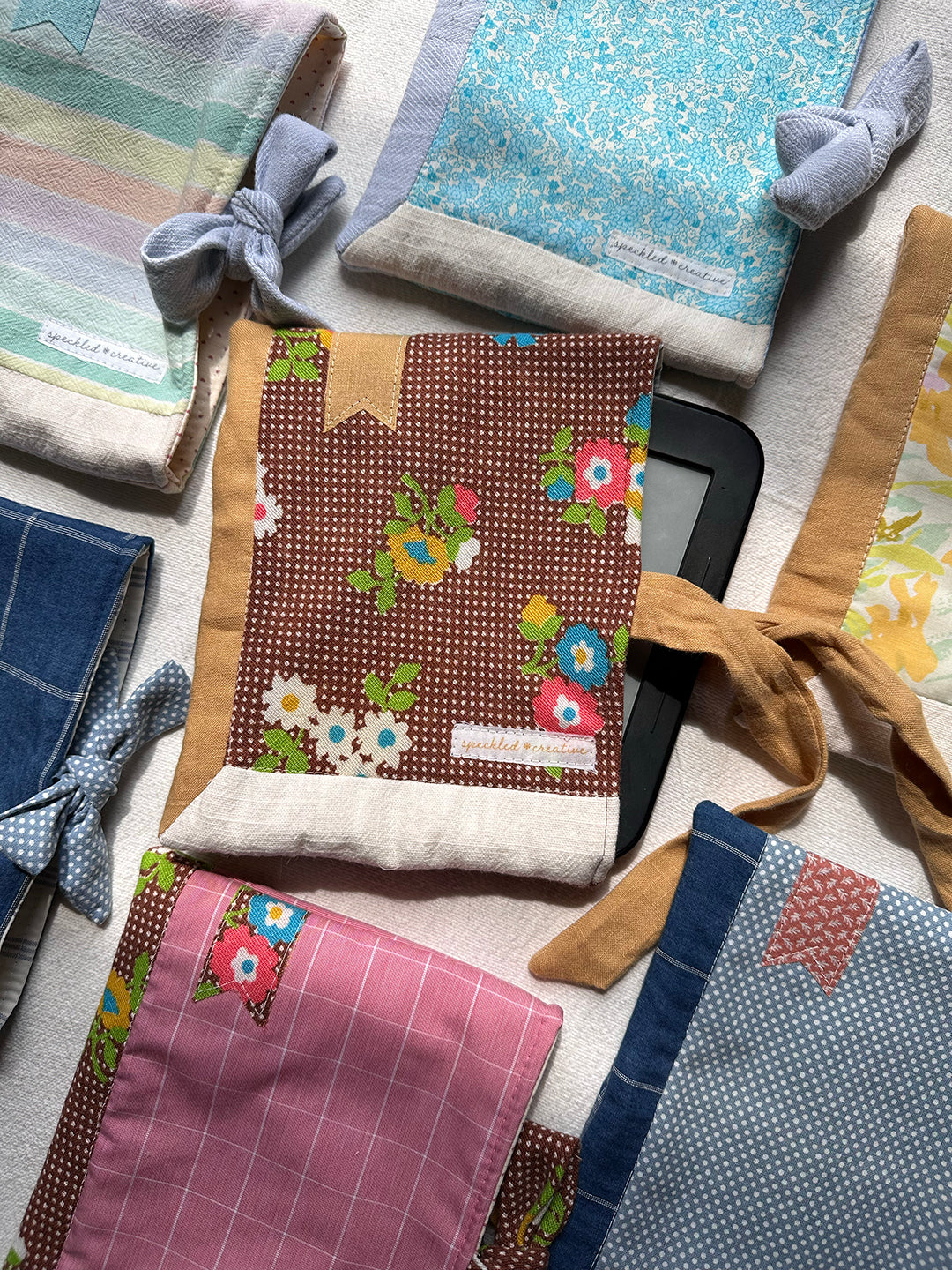 Handmade e-book sleeves in various fabrics