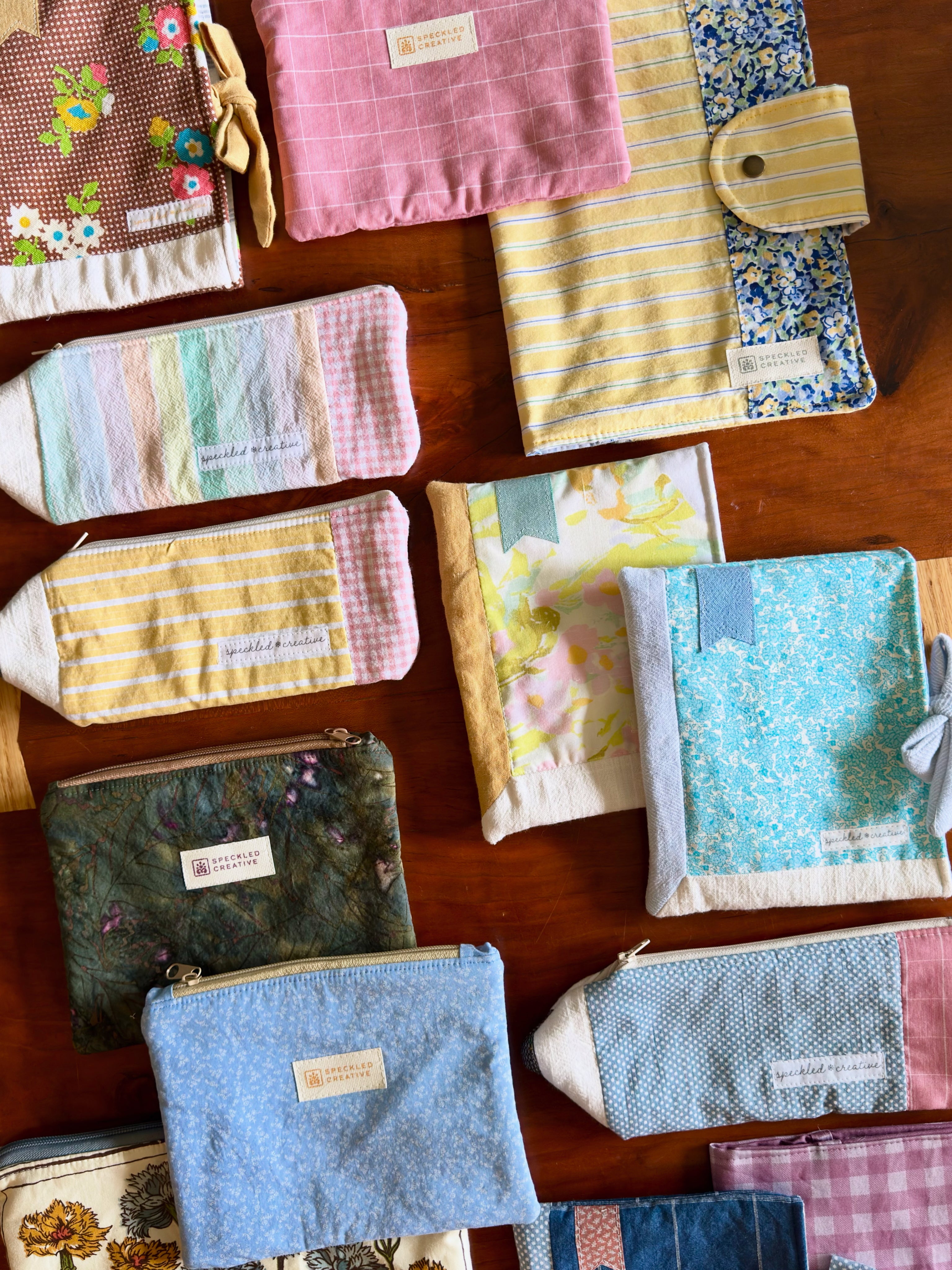 Collection of variously patterned fabric pouches on a wooden surface