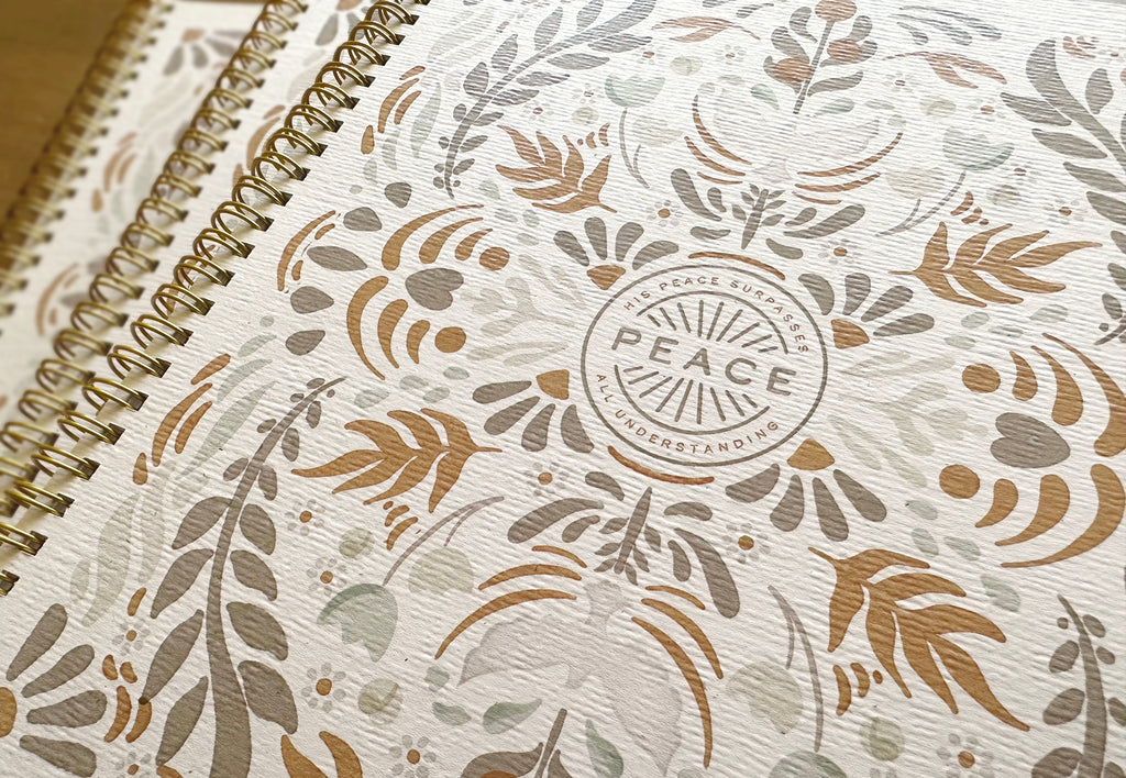 Notebook with floral pattern and 'PEACE' logo on cover