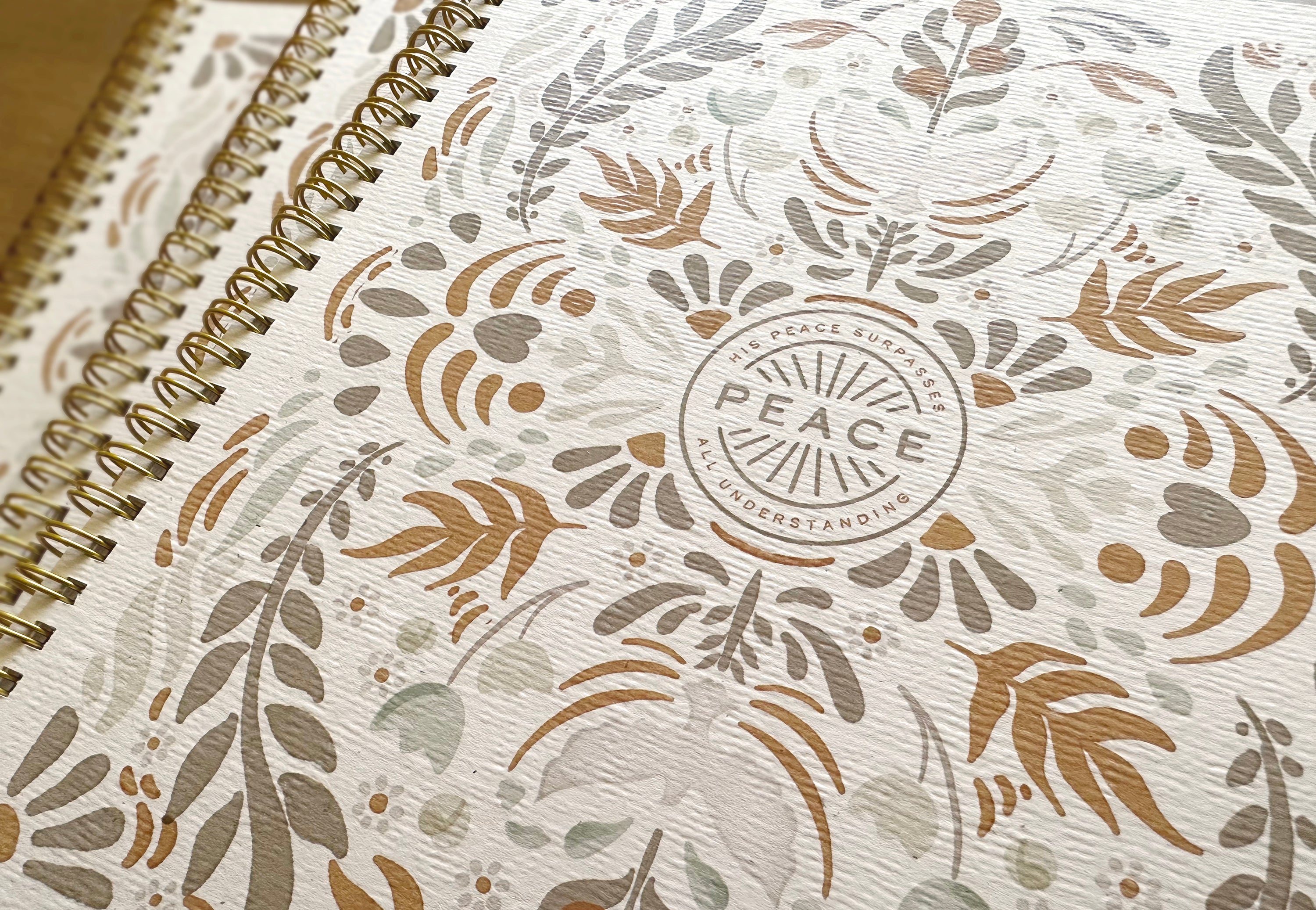 Notebook with floral pattern and 'PEACE' logo on cover