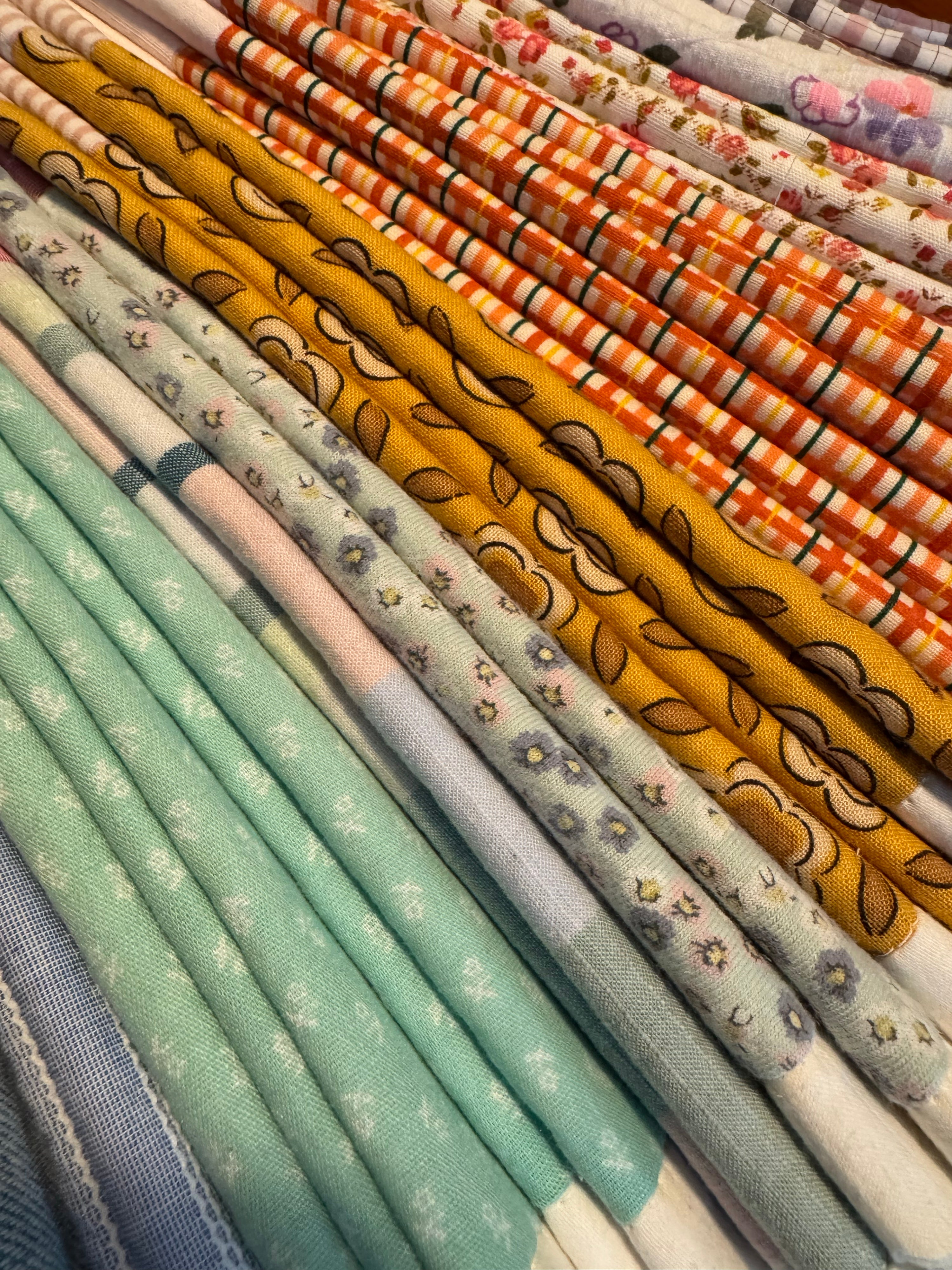 Collection of patterned fabric rolls in various colors