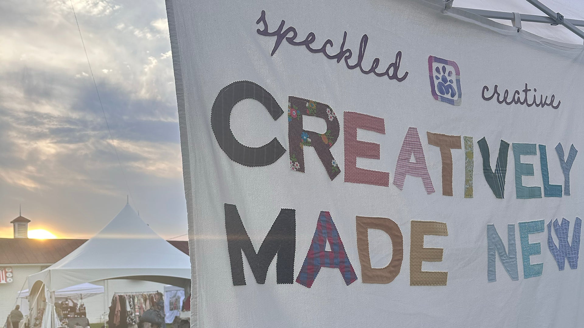 Speckled Creative banner with a sunset in the background