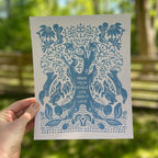 Art print with blue tree design and text that says "make your whole life about love" held by a hand outdoors
