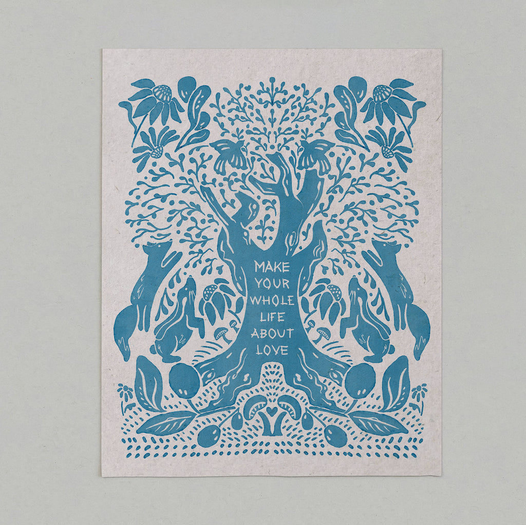 Art print with blue floral and animal design with motivational text that says "make your whole life about love" on a light gray background.
