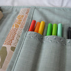 Colorful markers in slots in a fabric pouch