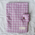 Purple and white checkered fabric with a button and Speckled Creative label on a white background
