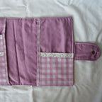 Purple fabric item with checkered pattern on a white background