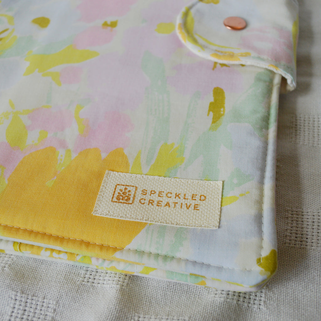 Floral-patterned product with Speckled Creative label on a textured background