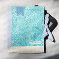 Blue and white patterned e-reader pouch with a e-reader inside on a light gray background
