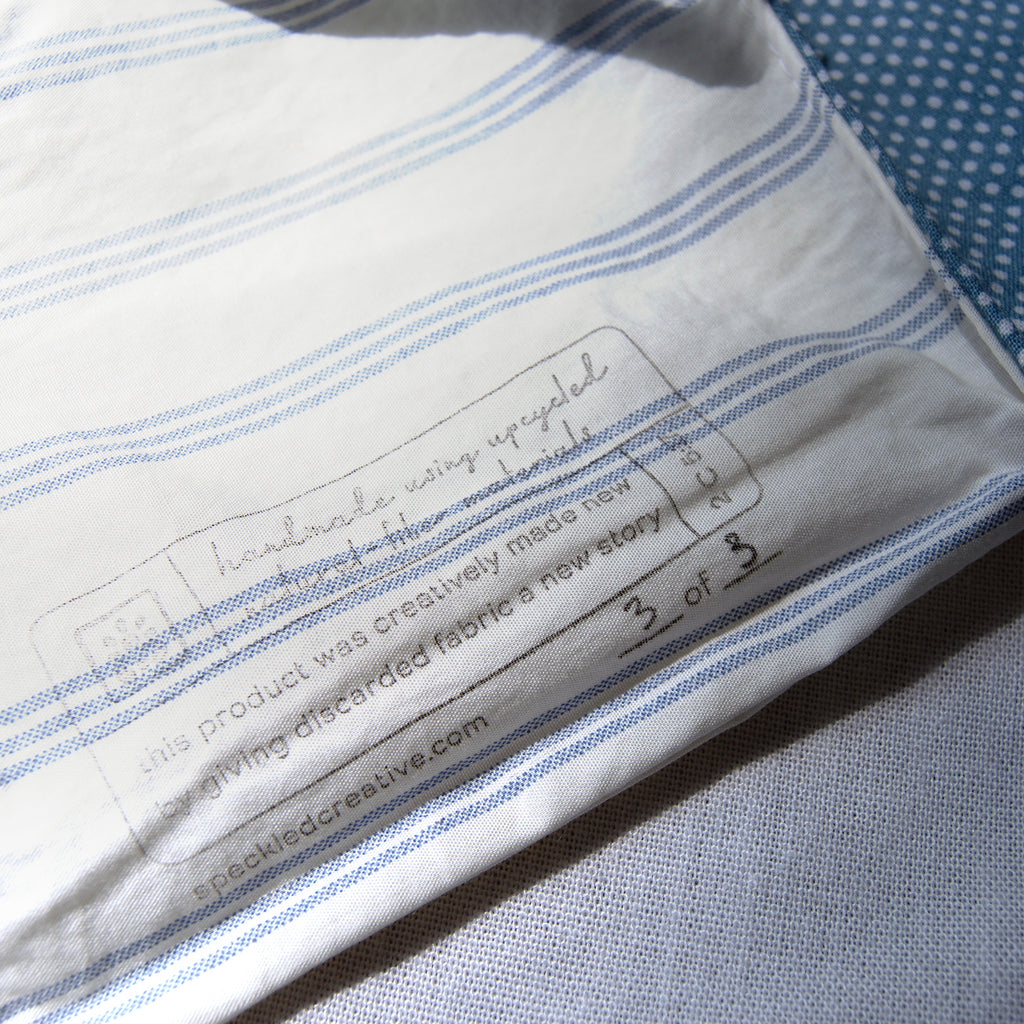 Close-up of a label on a piece of fabric with text and a website URL.