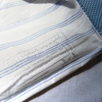 Close-up of a label on a piece of fabric with text and a website URL.