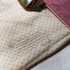 Close-up of fabric with a label and heart pattern