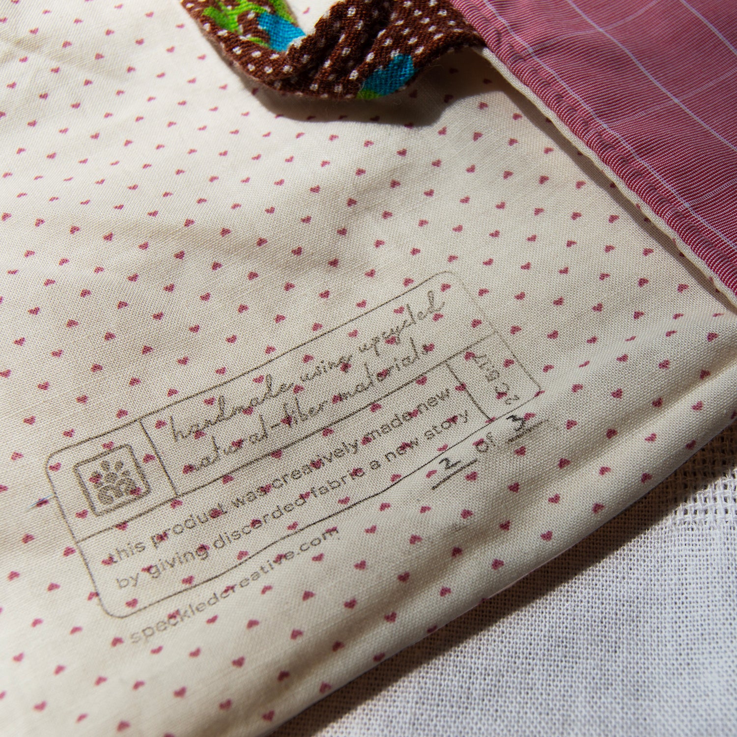 Close-up of fabric with a label and heart pattern