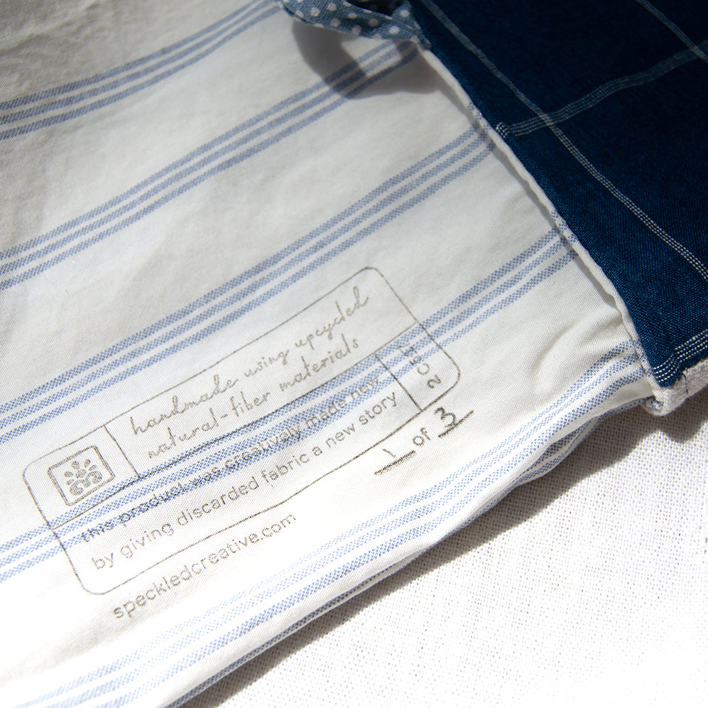 Close-up of a blue and white striped fabric with a label on a white background