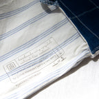 Close-up of a blue and white striped fabric with a label on a white background