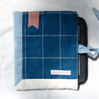 Blue checkered e-reader pouch with polka dot accents on a white background