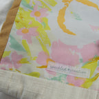 Floral patterned fabric e-reader sleeve with a 'speckled creative' label