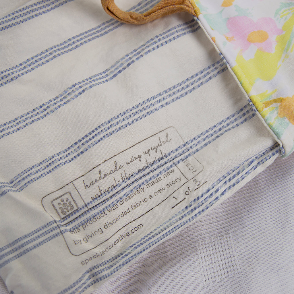 Close-up of a fabric product with a label on a striped background