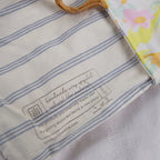Close-up of a fabric product with a label on a striped background