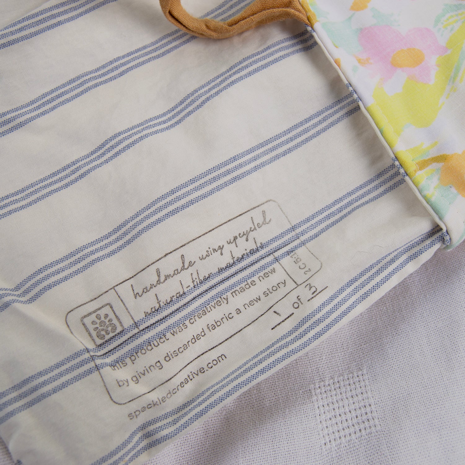 Close-up of a fabric product with a label on a striped background