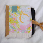 Floral patterned pouch with a brown border on a white background