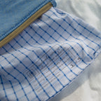 Close-up of a product with blue grid pattern and text on a white background