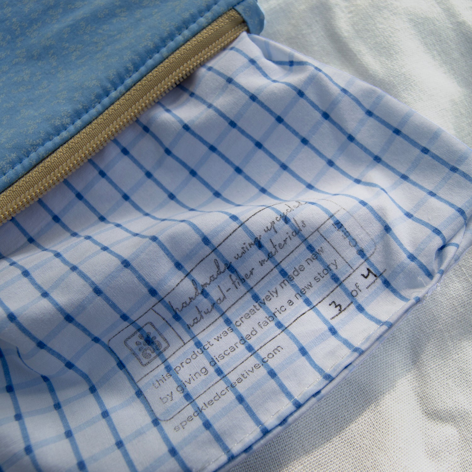Close-up of a product with blue grid pattern and text on a white background
