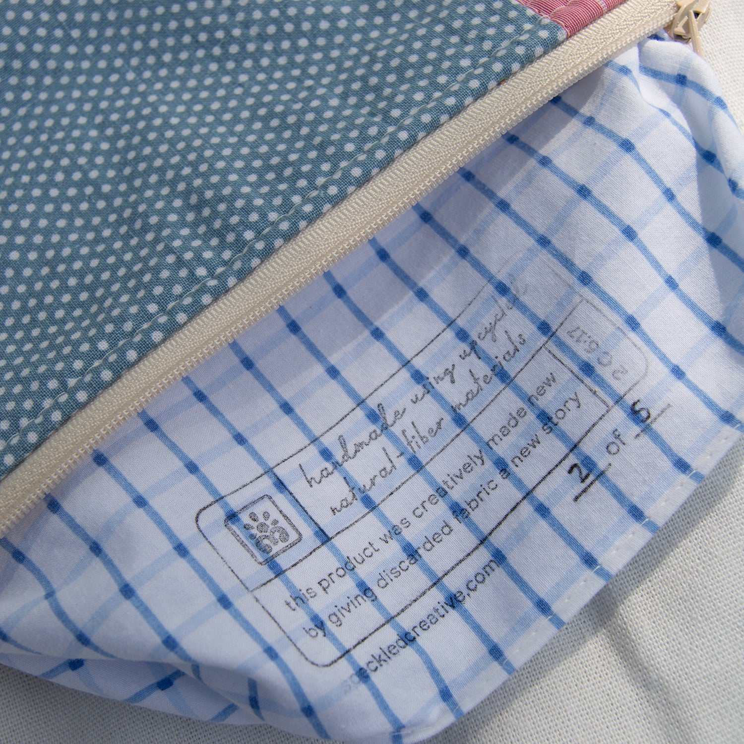 Close-up of a fabric product with blue and white checkered pattern and visible label.