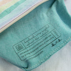 Close-up of a label on a piece of fabric with a brand logo.