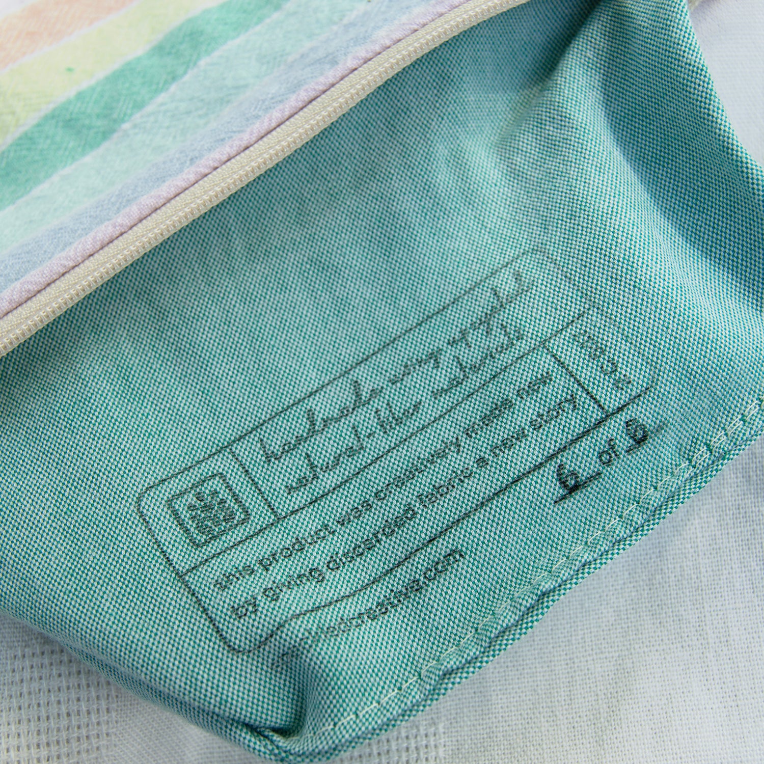 Close-up of a label on a piece of fabric with a brand logo.
