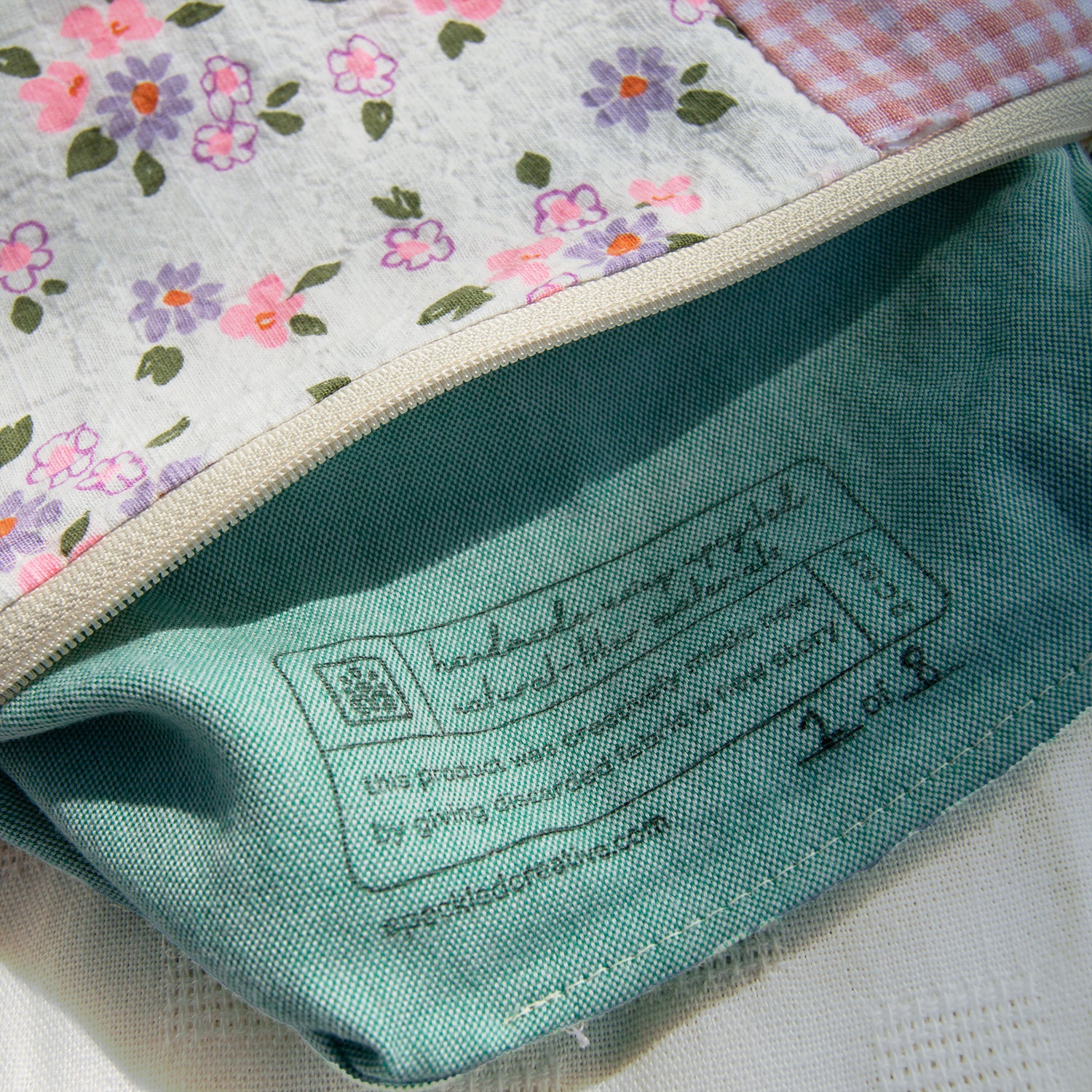 Close-up of a label on a fabric product with floral pattern