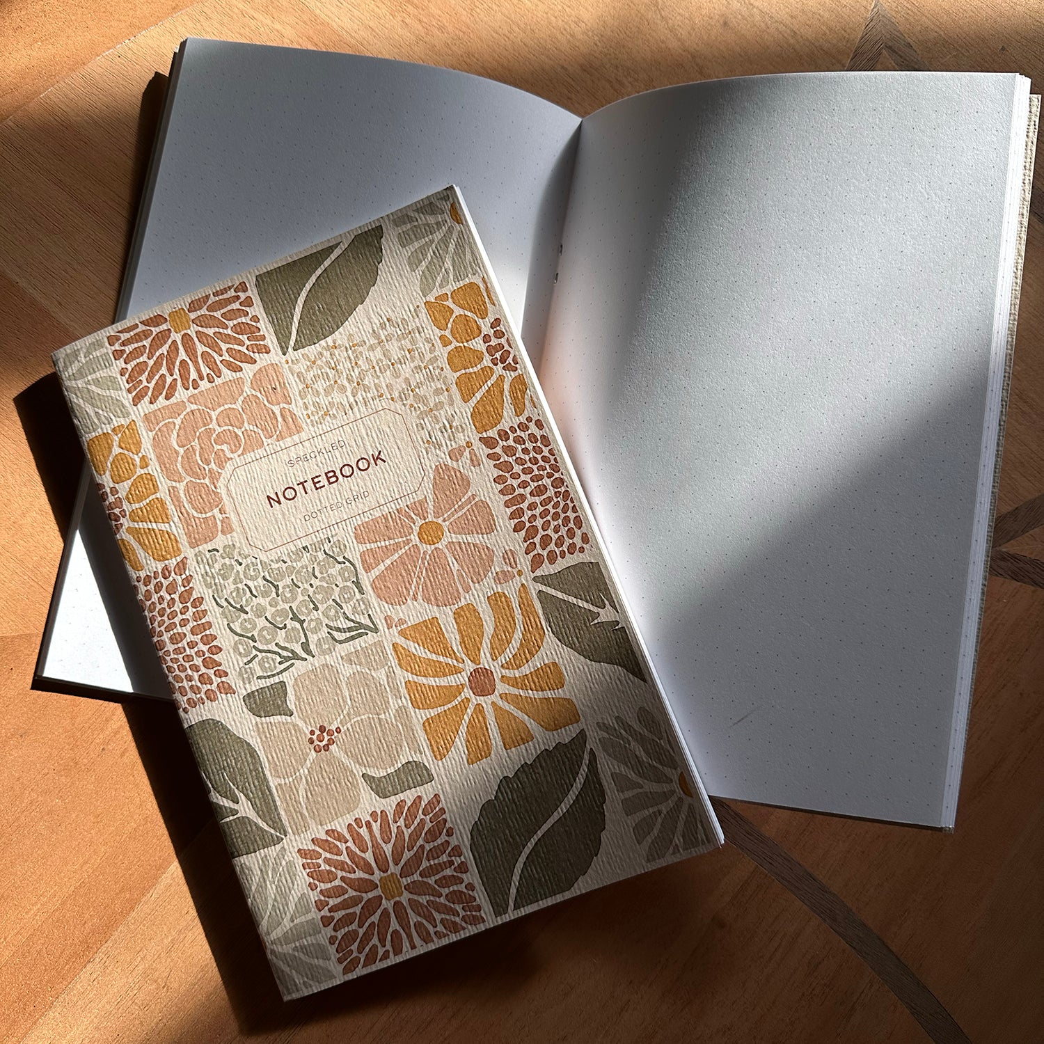 Floral-patterned notebook on a wooden surface