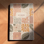 Notebook with floral pattern on a wooden surface