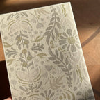 Notebook back with floral pattern on a wooden surface