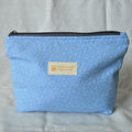 Blue fabric pouch with a Speckled Creative label