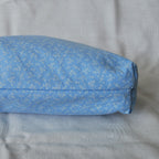 Bottom of a blue fabric pouch with a subtle pattern