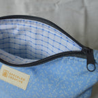 Blue patterned pouch with a dark blue zipper and Speckled Creative label 