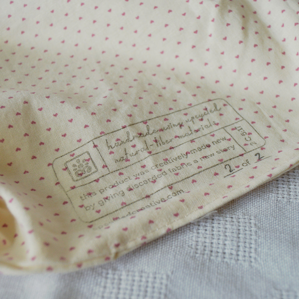 Close-up of a label on the lining with heart patterns of a pouch 
