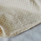 Close-up of a label on the lining with heart patterns of a pouch 