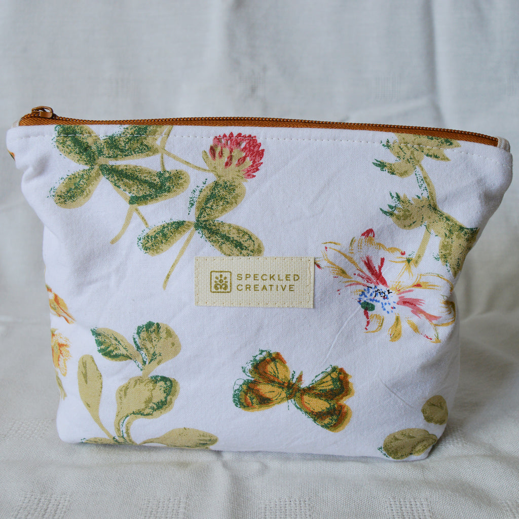 Floral-patterned pouch with 'Speckled Creative' label on a light background