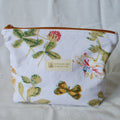 Floral-patterned pouch with 'Speckled Creative' label on a light background