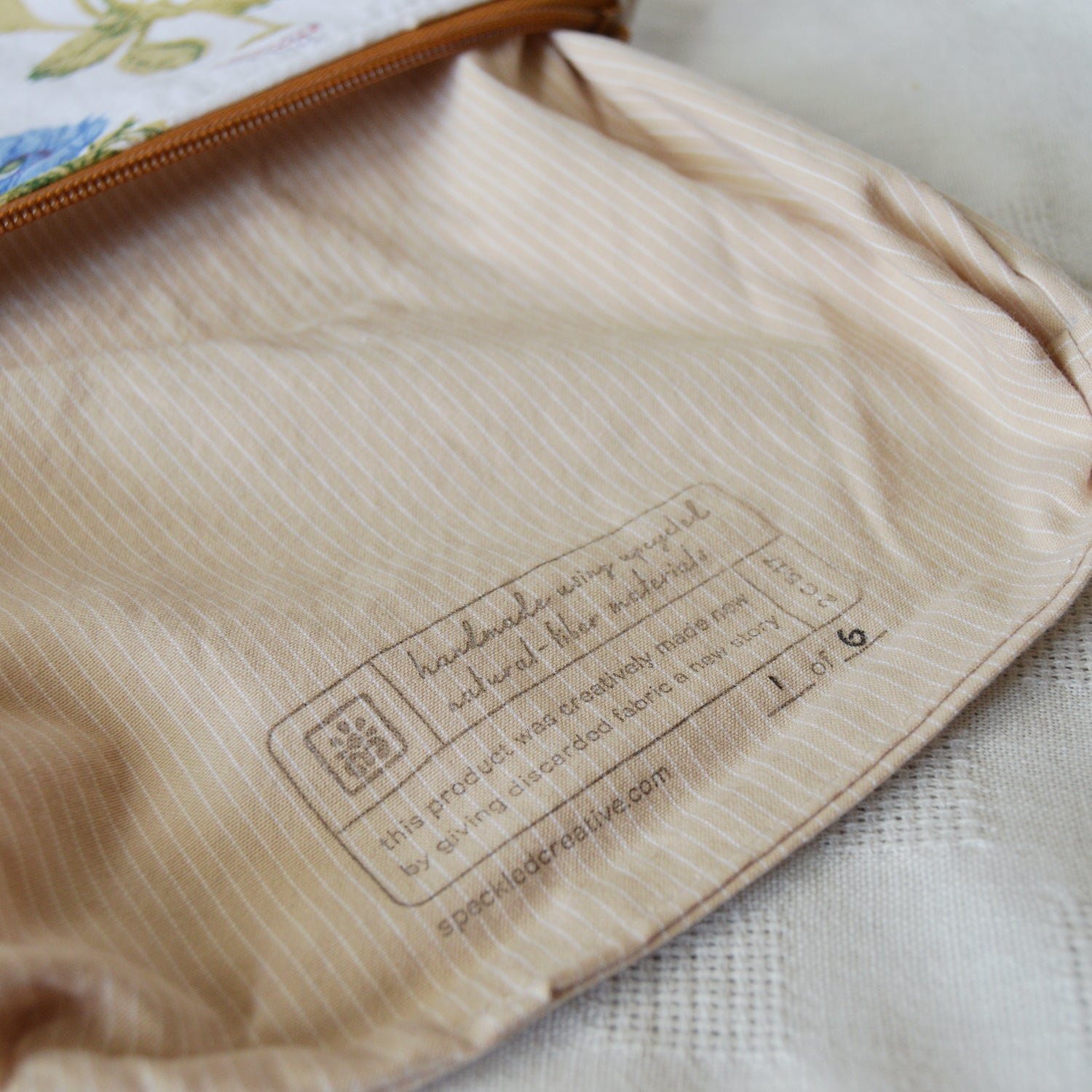 Close-up of a beige fabric with a label on a textured surface