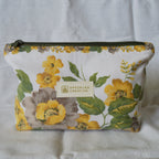 Floral pouch with 'Speckled Creative' label on a white background