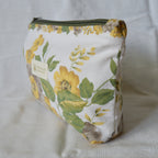 Fabric pouch with floral design on a plain background