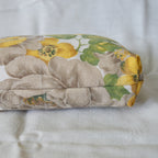 Bottom of pouch with floral-patterned fabric roll on a white background