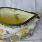 Close up of floral-patterned pouch with a zipper on a white background
