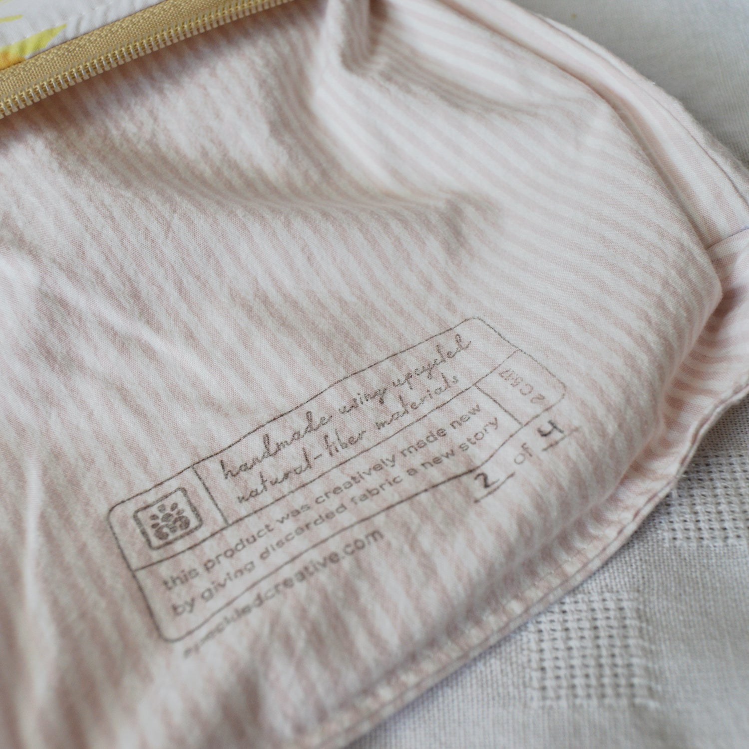 Close-up of a label on a pink textured fabric with a blurred background