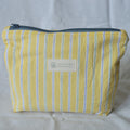 Yellow striped pouch with a Speckled Creative label on a light gray background